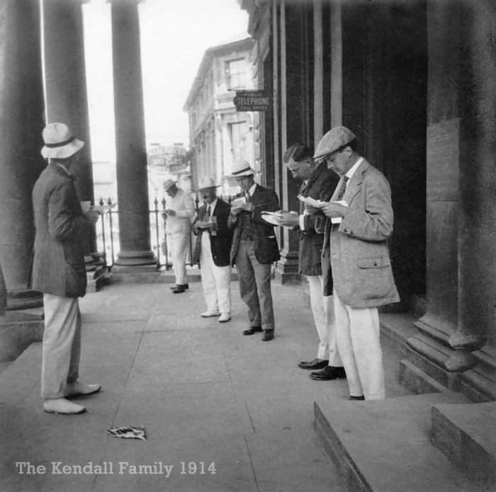 Reading letters outside Norwich Post Office